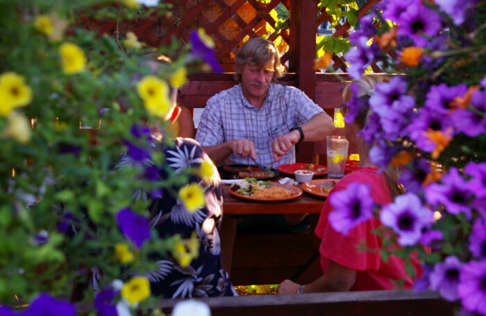 MAN EATS THROUGH FLOWERS